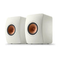 Pair of white speakers with copper accents, KEF LS50 Meta Bookshelf Speakers